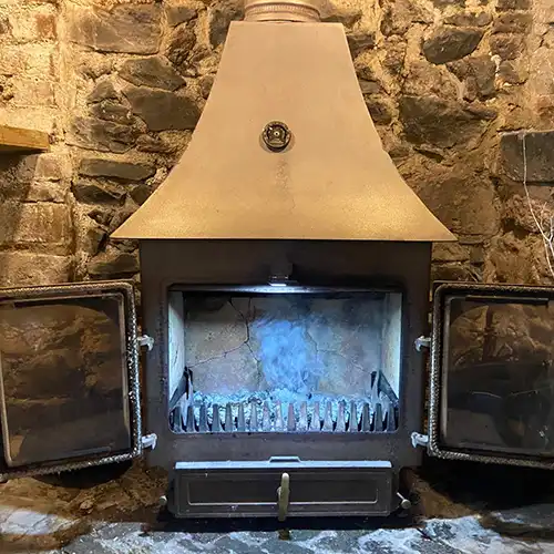 A wood burner before repair work