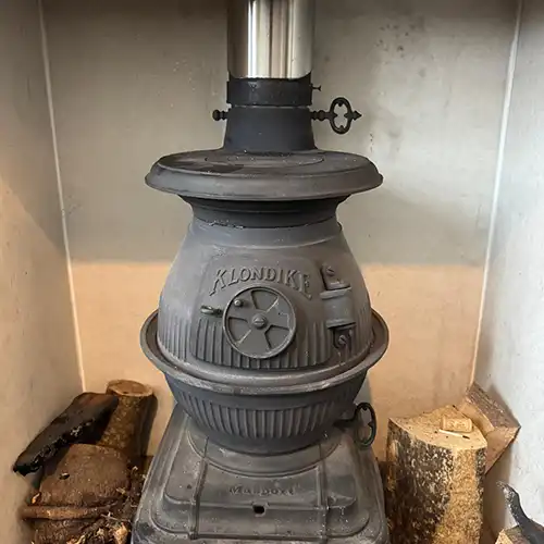Wood burner with sweeping access installed